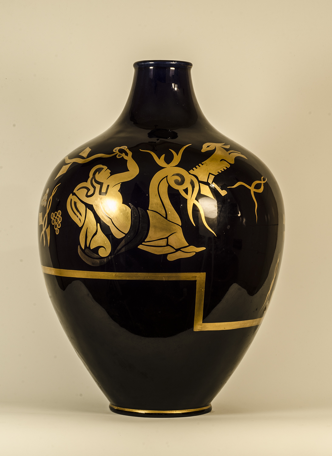 A French Art-Deco period blue porcelain vase, with golden and silvered decoration. Ca 1930